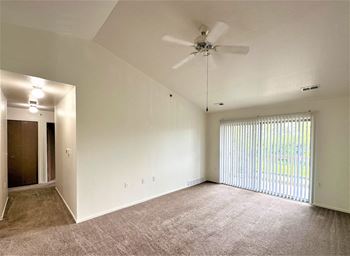 an empty living room with a ceiling fan and a window at Windsor Place, Michigan